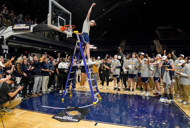 Chattanooga Mocs forward Collin Mulholland (21) celebrates after cutting the net Thursday, April 3, 2025, during the National Invitational Tournament at Hinkle Fieldhouse in Indianapolis.