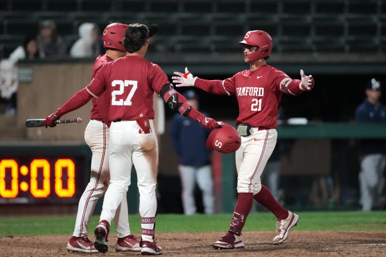 Stanford Cardinal designated hitter Charlie Saum (21) celebrates with right fielder Brady Reynolds (27) and second baseman Jimmy Nati (back left) after hitting a home run against the Xavier Musketeers during the eighth inning at Sunken Diamond.