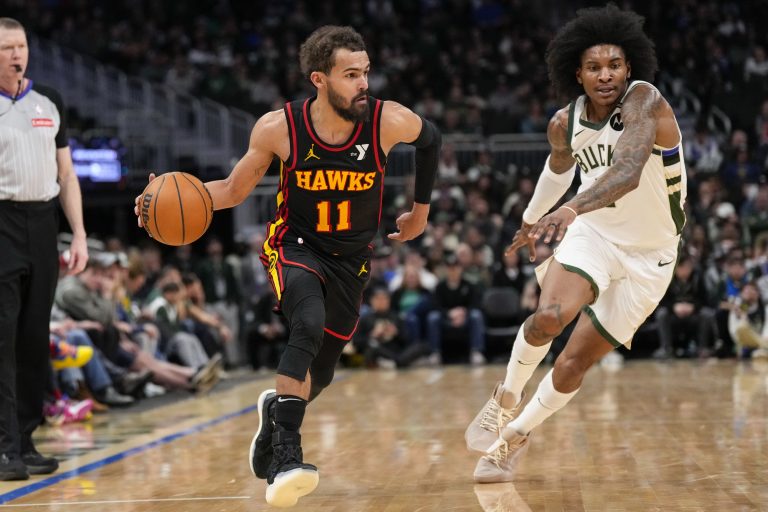 Atlanta Hawks guard Trae Young (11) drives for the basket in front of Milwaukee Bucks guard Kevin Porter Jr. (3) during the fourth quarter at Fiserv Forum.
