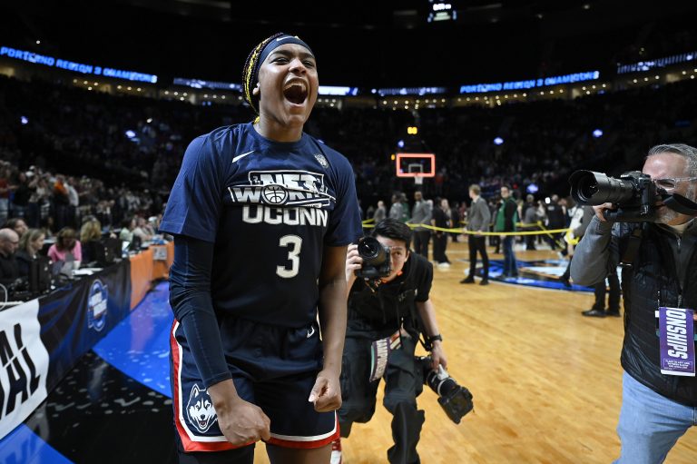 UConn Huskies forward Aaliyah Edwards (3) celebrate after beating the USC Trojans in the finals of the Portland Regional of the NCAA Tournament at the Moda Center.
