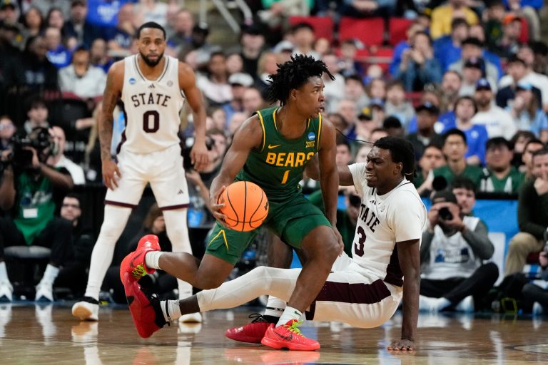 Baylor Bears guard Robert Wright III (1) dribbles the ball against Mississippi State Bulldogs forward KeShawn Murphy (3) during the second half in the first round of the NCAA Tournament at Lenovo Center.
