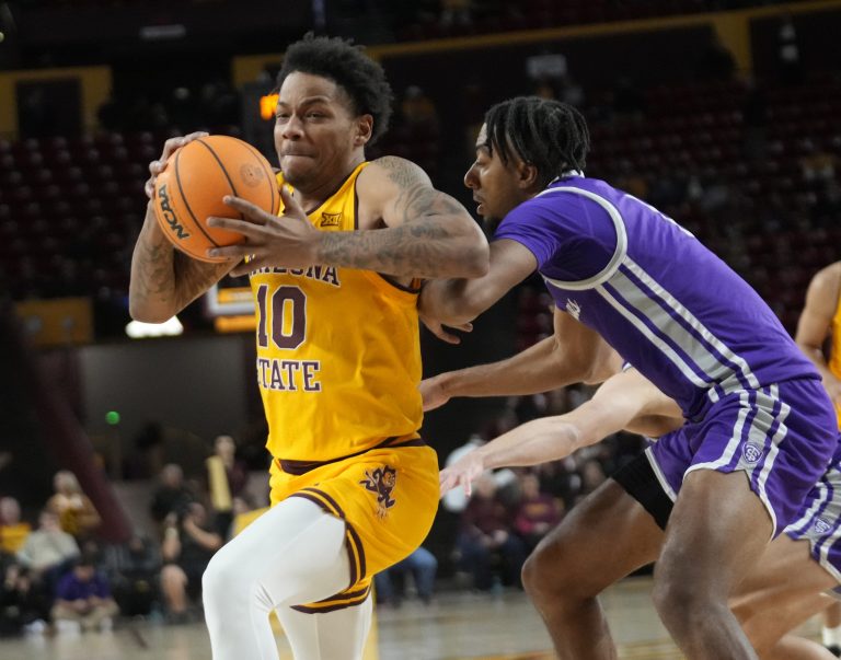 Arizona State forward Brandon Gardner (0) spins away from St. Thomas guard Kendall Blue
