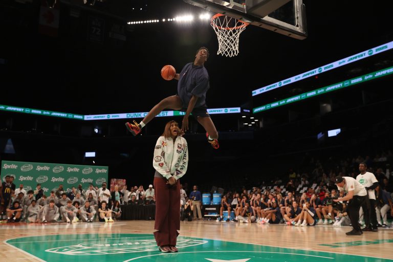 McDonald’s All American West forward AJ Dybantsa (3) dunks the ball over Chicago Sky forward Angel Reese during the Sprite Jam Fest at Barclay's Center