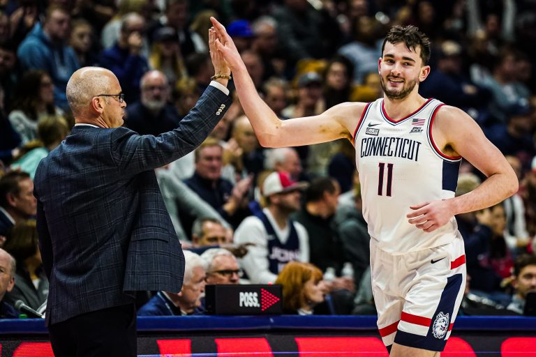 Connecticut Huskies head coach Dan Hurley congratulates forward Alex Karaban (11) coming off the court as they take on the DePaul Blue Demons