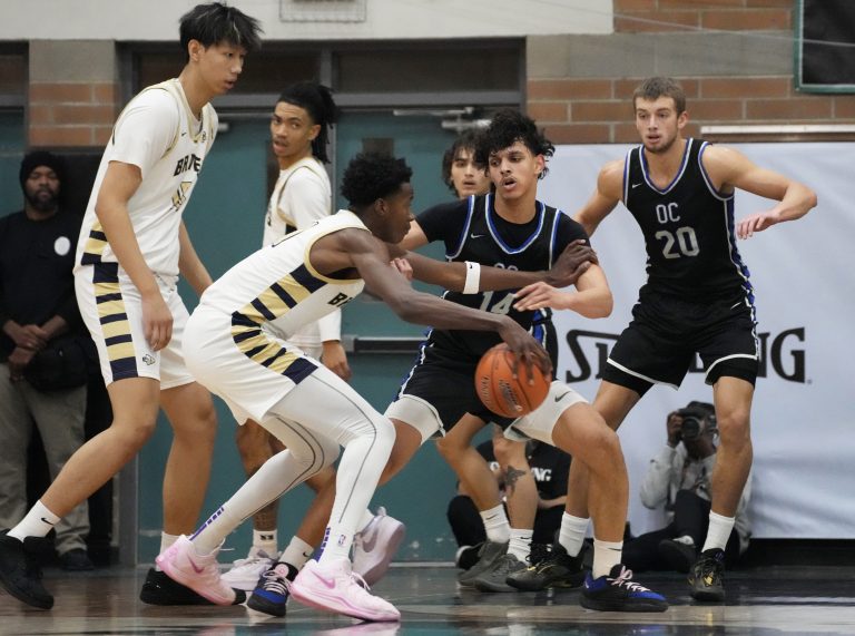 St. John Bosco's Christian Collins (11) dribbles the ball while being guarded by Sandra Day O'Connor's Colton Watson (14) during the Nike Tournament of Champions