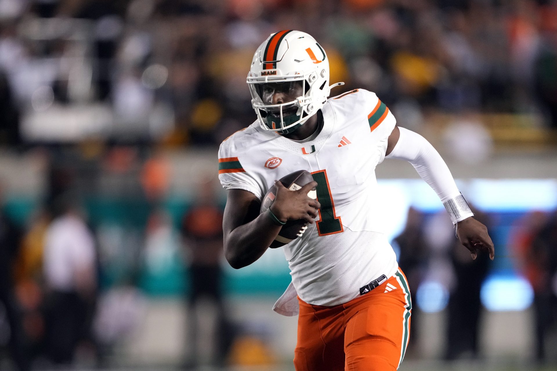 Miami Hurricanes quarterback Cam Ward (1) rushes for a touchdown /across the/ during the fourth quarter at California Memorial Stadium.