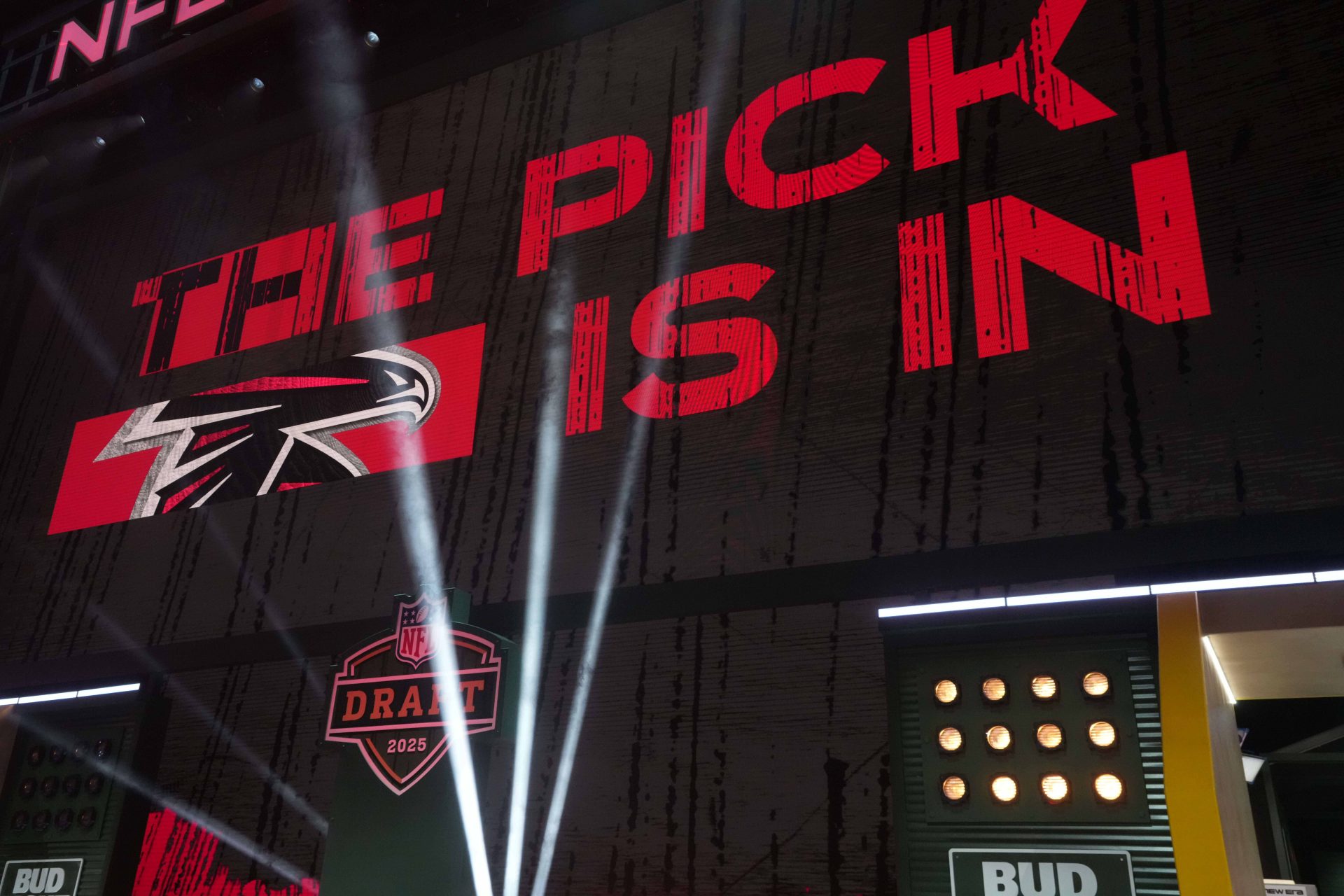 The Atlanta Falcons logo is projected on the video board during the NFL Draft at Lambeau Field.