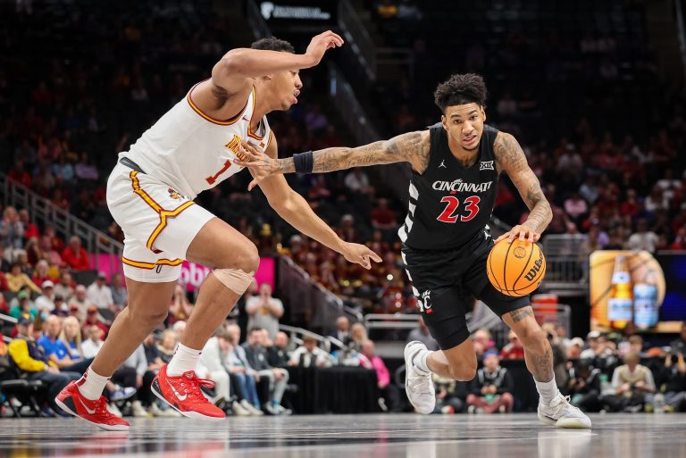 ansas City, MO, USA; Cincinnati Bearcats forward Dillon Mitchell (23) brings the ball up court around Iowa State Cyclones center Dishon Jackson (1) during the second half at T-Mobile Center.