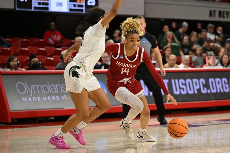 Harvard Crimson guard Harmoni Turner (14) drives past Michigan State Spartans guard Jocelyn Tate (11) during the second half at James T. Valvano Arena at William Neal Reynolds.