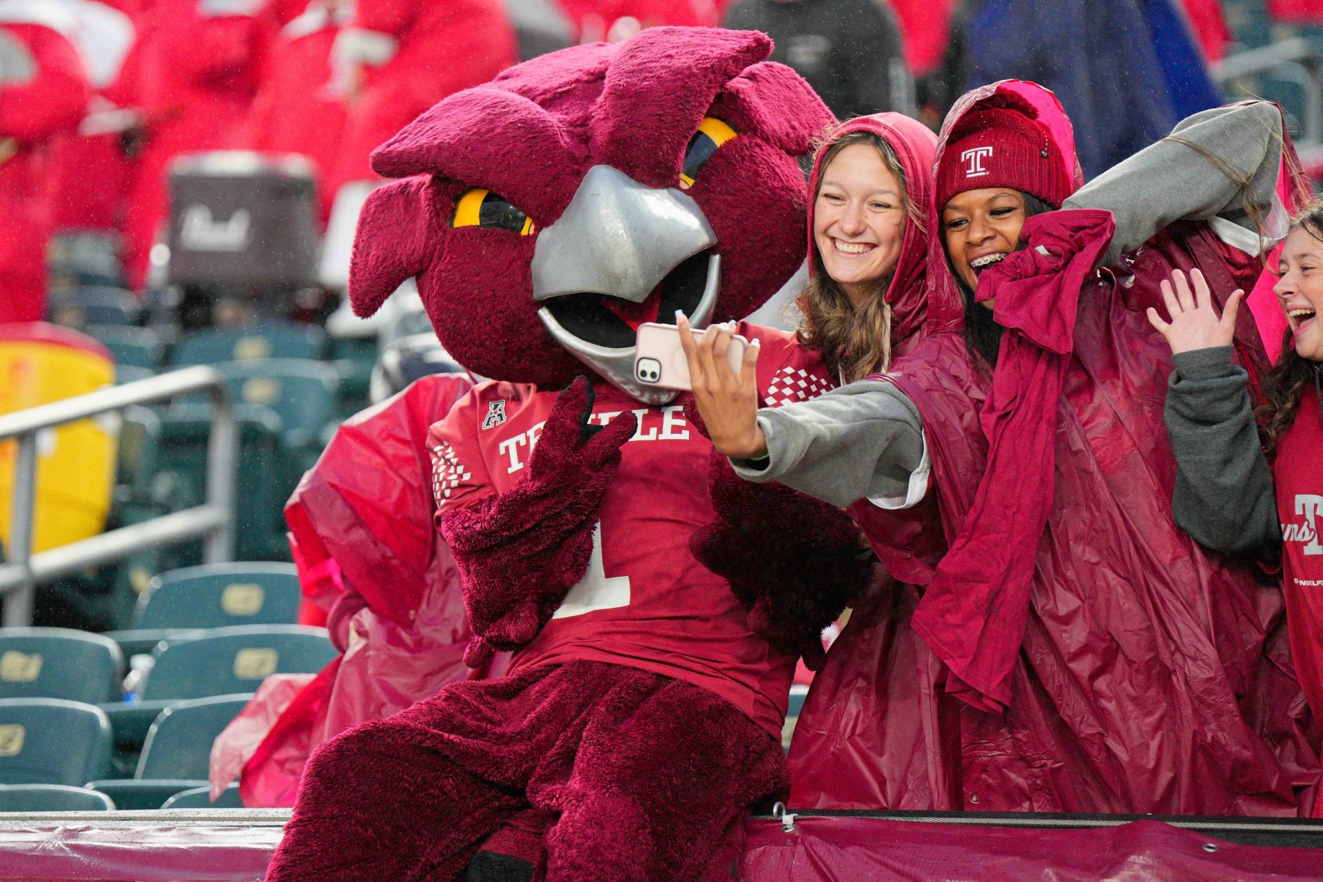 Temple Owls mascot Hooter poses for a picture with fans after the game against the Miami Hurricanes at Lincoln Financial Field.