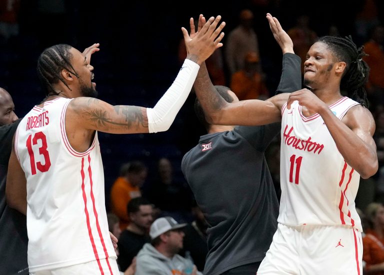 Houston Cougars forward J'Wan Roberts (13) high fives forward Joseph Tugler (11) as he comes off the court during a game against the Tennessee Volunteers