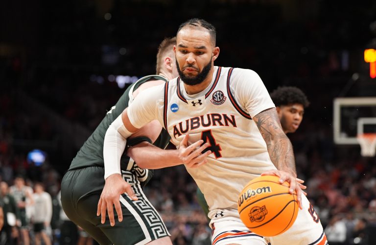 Auburn Tigers forward Johni Broome (4) drives against Michigan State Spartans forward Jaxon Kohler (0) during the second half in the South Regional final of the 2025 NCAA tournament at State Farm Arena.