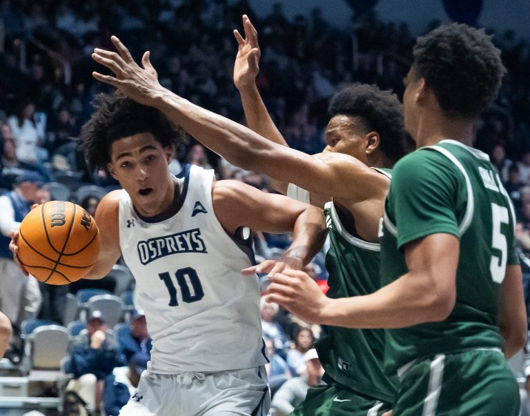 North Florida Ospreys guard Jasai Miles (0) is pressured by the JU defense.