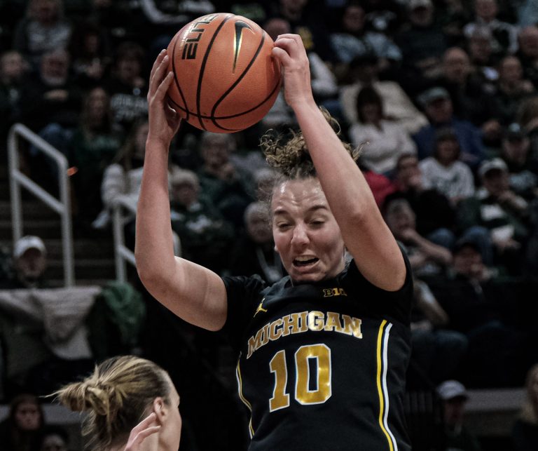 Michigan's Jordan Hobbs (10) pulls down a rebound against Michigan State