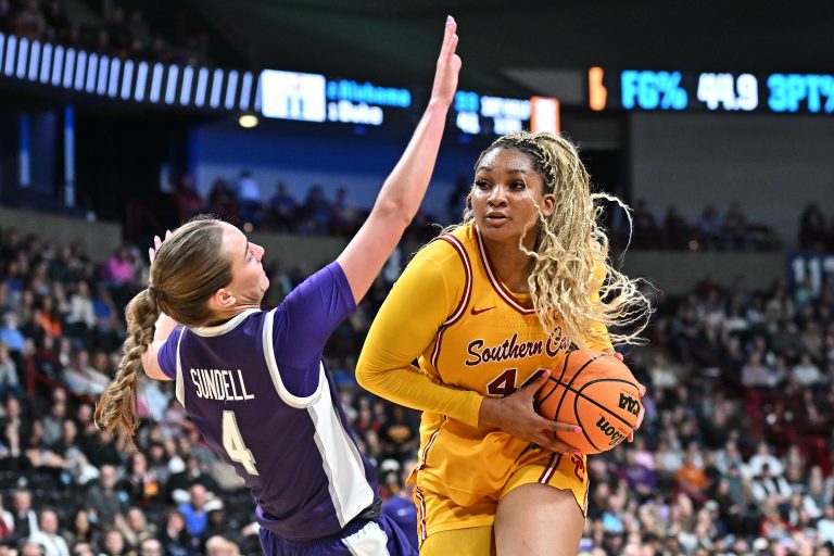 Kansas State Wildcats guard Serena Sundell (4) takes a charge from USC Trojans forward Kiki Iriafen (44) during the second half of a Sweet 16 NCAA Tournament basketball game against the Kansas State Wildcats at Spokane Arena.