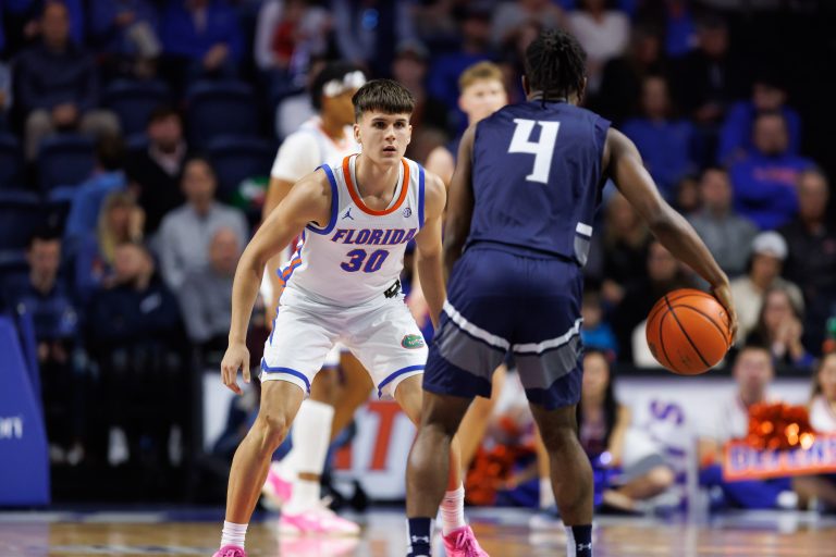 Florida Gators guard Kajus Kublickas (30) defends North Florida Ospreys guard Jaylen Smith (4) during the second half at Exactech Arena at the Stephen C. O'Connell Center.
