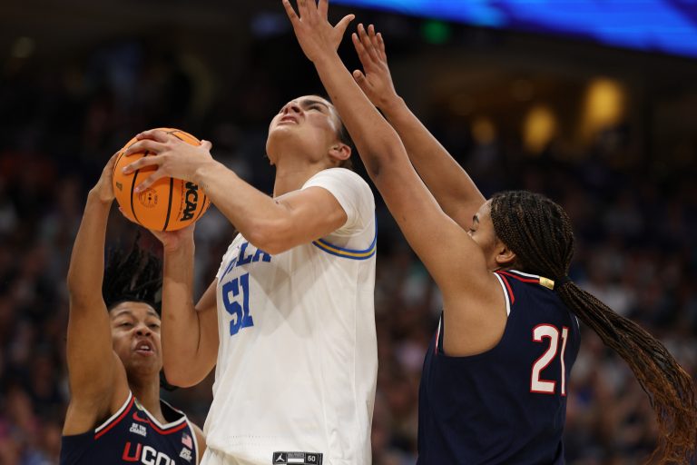 UCLA Bruins center Lauren Betts (51) drives against Connecticut Huskies forward Sarah Strong (21) and Connecticut Huskies guard KK Arnold (2) during first half in a semifinal of the women's 2025 NCAA tournament at Amalie Arena.