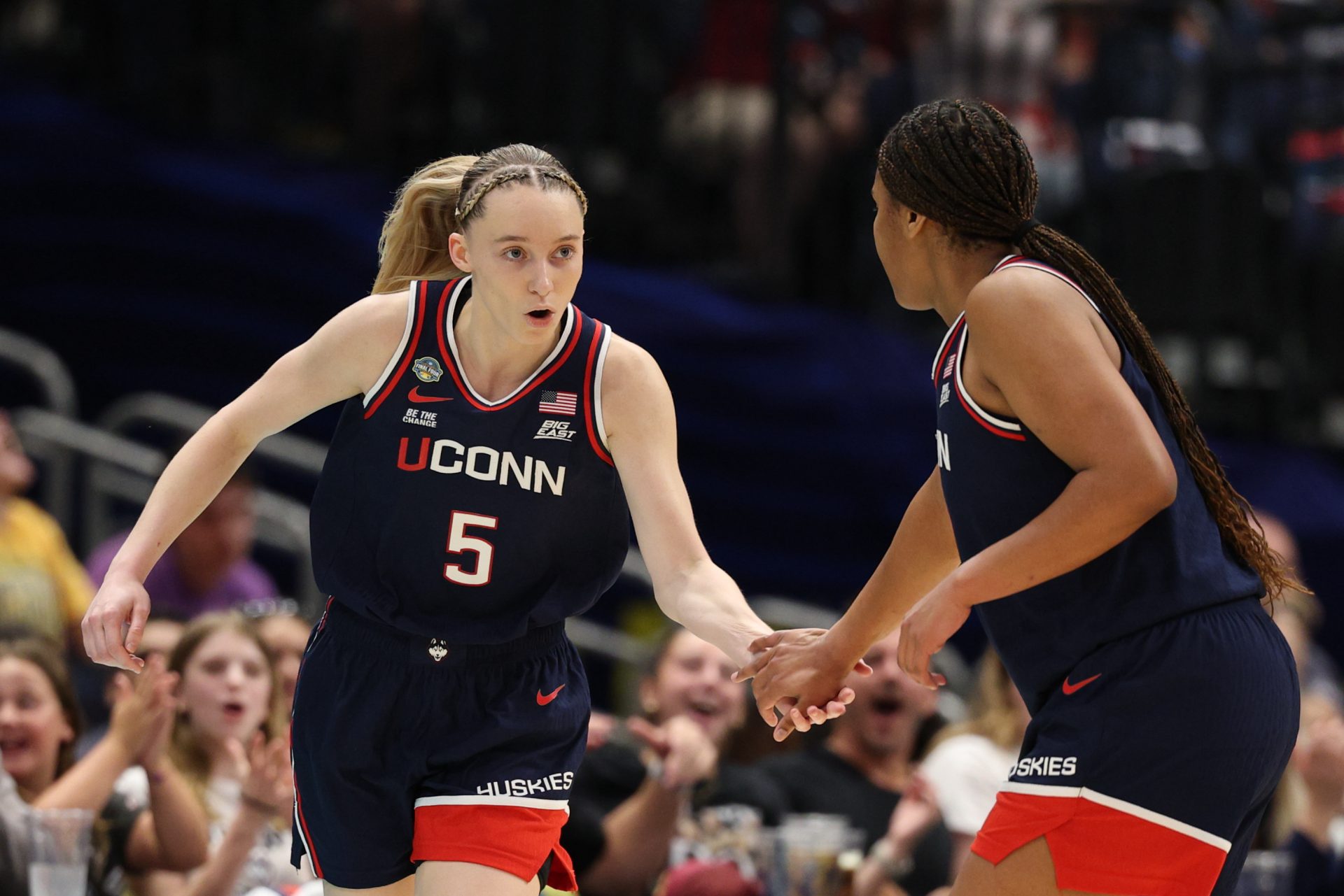 Connecticut Huskies guard Paige Bueckers (5) high fives Connecticut Huskies forward Sarah Strong (21) during first half in a semifinal of the women's 2025 NCAA tournament against the UCLA Bruins at Amalie Arena.