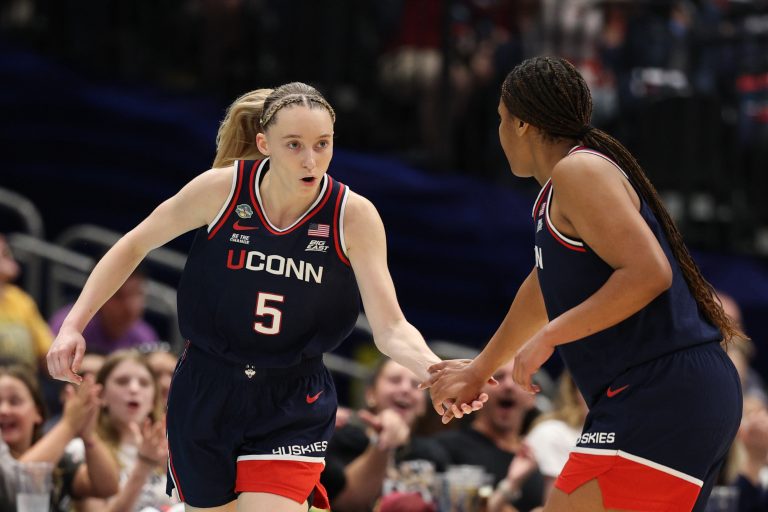 Connecticut Huskies guard Paige Bueckers (5) high fives Connecticut Huskies forward Sarah Strong (21) during first half in a semifinal of the women's 2025 NCAA tournament against the UCLA Bruins at Amalie Arena.