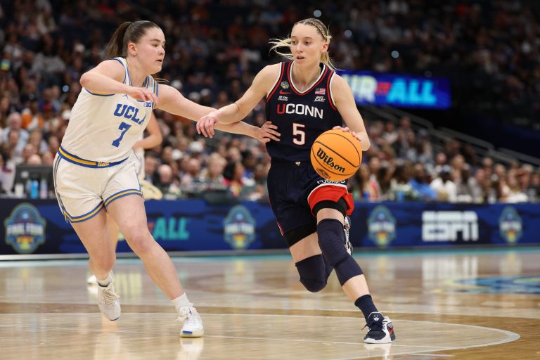 Connecticut Huskies guard Paige Bueckers (5) dribbles against UCLA Bruins guard Elina Aarnisalo (7) during the third quarter in a semifinal of the women's 2025 NCAA tournament at Amalie Arena.