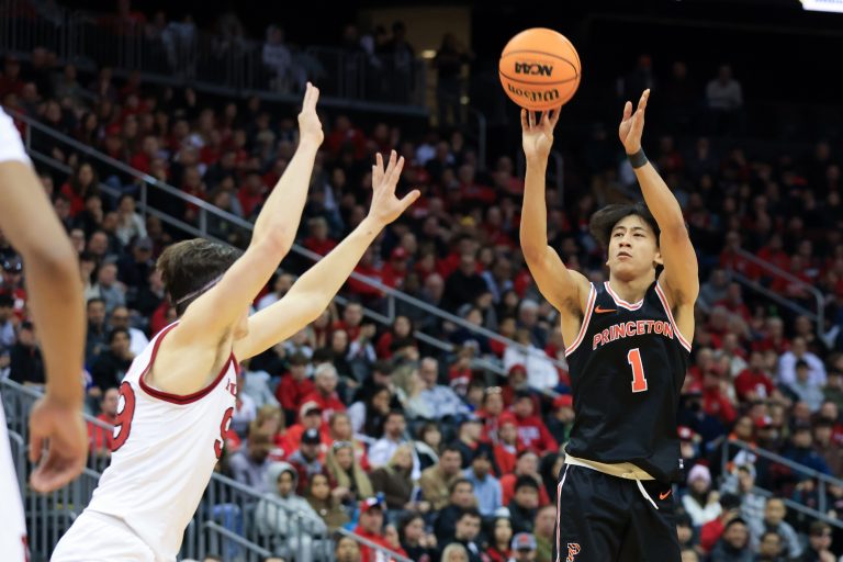 Princeton Tigers guard Xaivian Lee (1) shoots a three point basket while being guarded by Rutgers Scarlet Knights center Zach Martini (99) during the second half at Prudential Center.