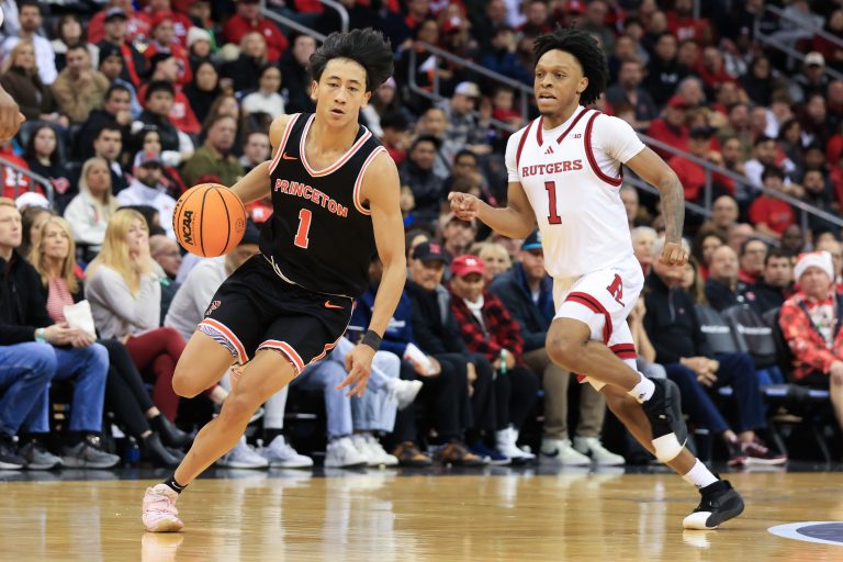 Princeton Tigers guard Xaivian Lee (1) dribbles up the court past Rutgers Scarlet Knights guard Jamichael Davis (1) during the second half at Prudential Center.