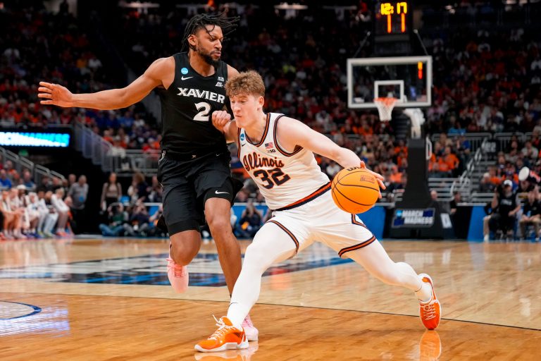 Illinois Fighting Illini guard Kasparas Jakucionis (32) drives against Xavier Musketeers forward Jerome Hunter (2) in the first half of the NCAA Tournament First Round game