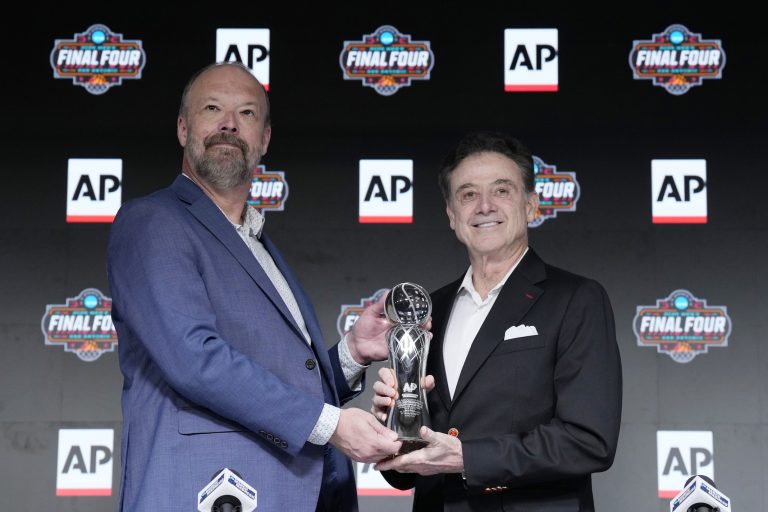 Barry Bedlan of the associated press introduces St. John's head coach Rick Pitino as one of the head coaches of the Coach of the Year award at Alamodome.