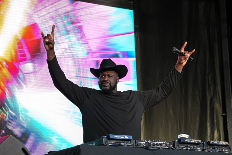 Shaquille O'Neal holds up the sign of the horns during a DJ performance ahead of the College Football Playoff semifina