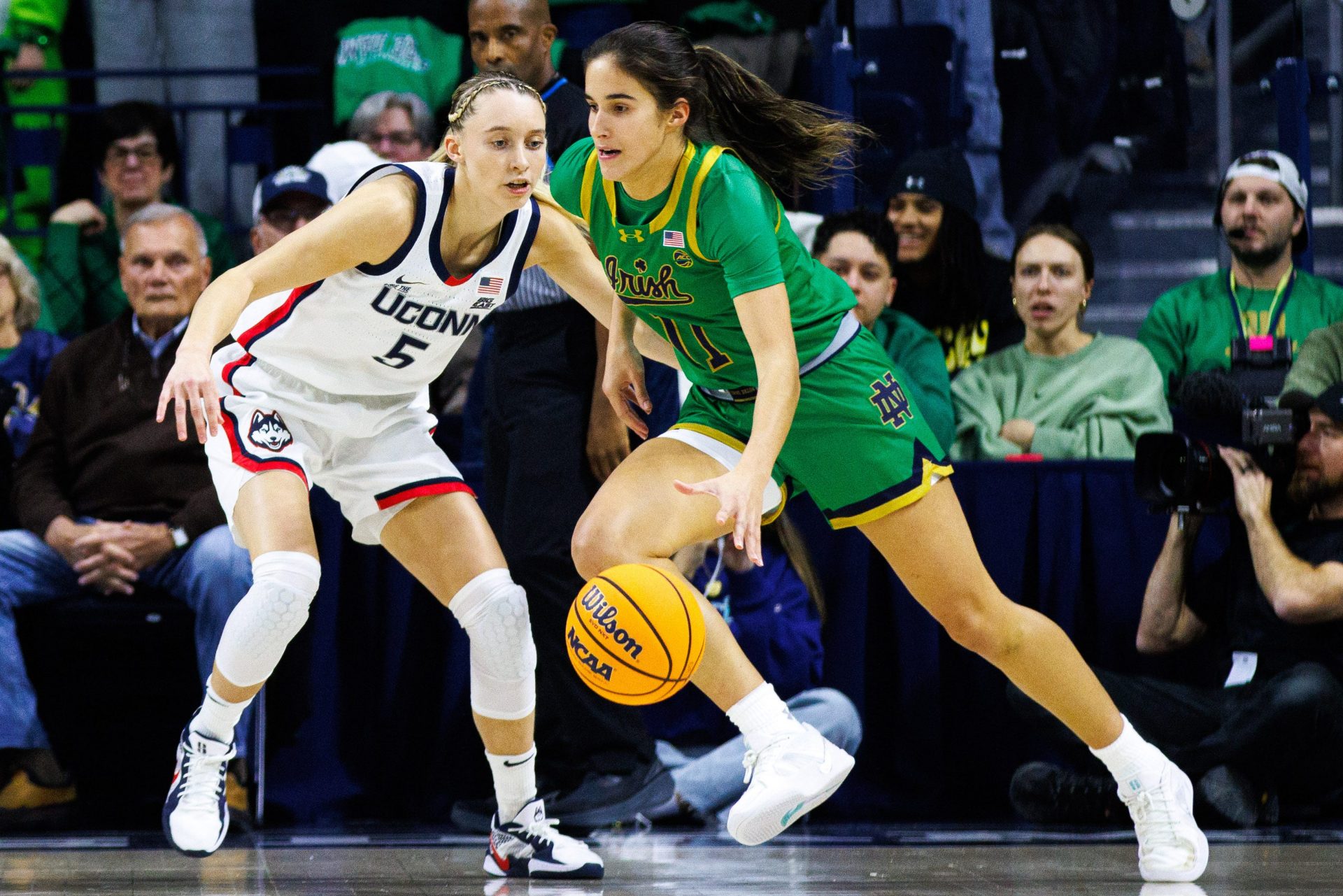 Notre Dame guard Sonia Citron (11) drives past UConn guard Paige Bueckers (5) during a NCAA women's basketball game between No. 8 Notre Dame and No. 2 UConn