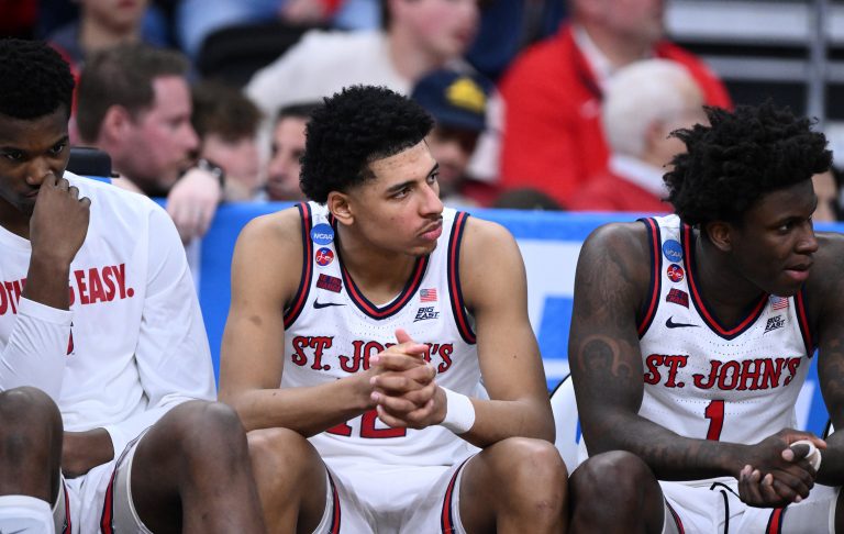 St. John's Red Storm guard RJ Luis Jr. (12), guard Kadary Richmond (1) and teammates on the bench during the second half of a second round men’s NCAA Tournament game against the Arkansas Razorbacks at Amica Mutual Pavilion.
