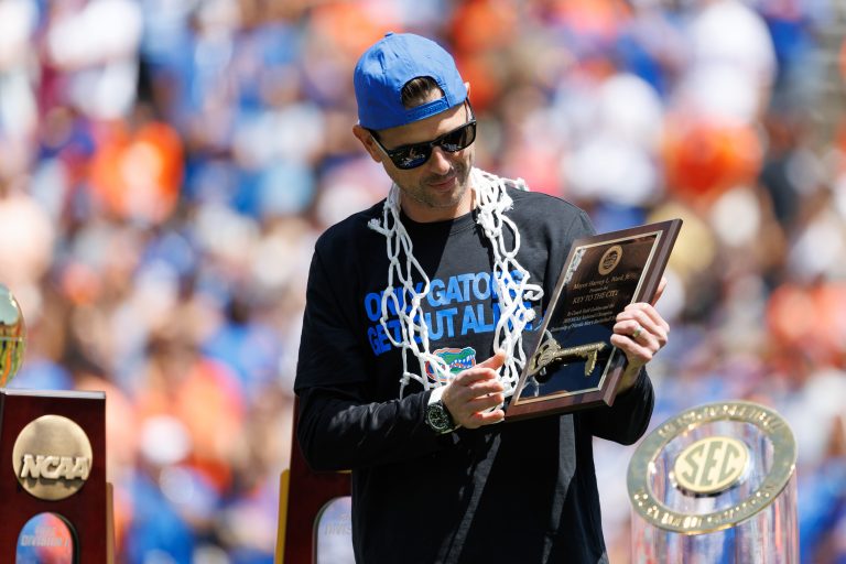 Florida Gators head coach Todd Golden holds the City of Gainesville Key to the City during the National Championship celebration at Ben Hill Griffin Stadium.