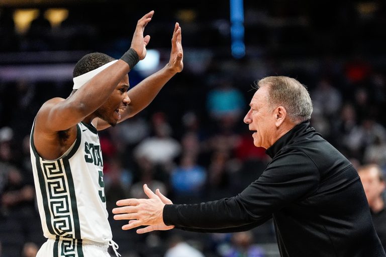 Michigan State head coach Tom Izzo talks to guard Tre Holloman (5) after a play against Oregon during the second half of Big Ten Tournament quarterfinal