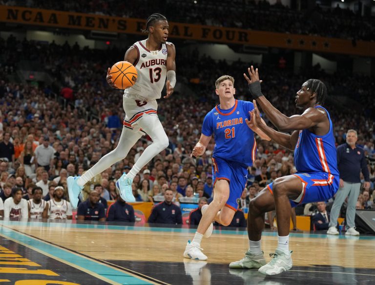 Auburn Tigers guard Miles Kelly (13) looks to pass th ball against the Florida Gators in the semifinals of the men's Final Four of the 2025 NCAA Tournament at the Alamodome.