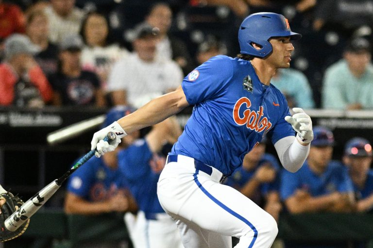 Florida Gators first baseman Jac Caglianone (14) singles in the Texas A&M Aggies during the eighth inning at Charles Schwab Field Omaha.