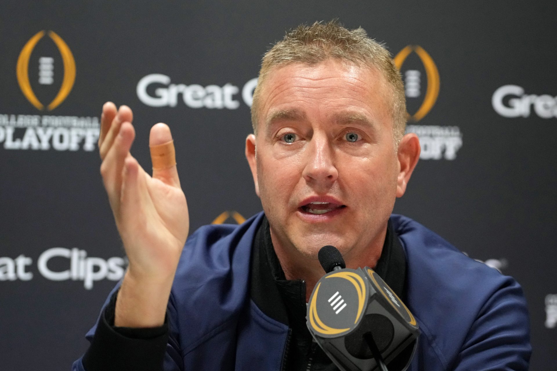 Kirk Herbstreit talks to the media during 2025 CFP National Championship Media Day at Georgia World Congress Center, Building A.