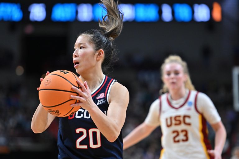 UConn Huskies guard Kaitlyn Chen (20) takes the inbounds pass against USC Trojans guard Avery Howell (23) during the second half of a Elite 8 NCAA Tournament basketball game at Spokane Arena.