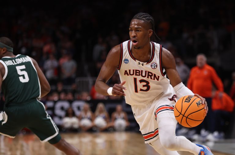 Auburn Tigers guard Miles Kelly (13) dribbles during the first half in the South Regional final of the 2025 NCAA tournament against the Michigan State Spartans at State Farm Arena.
