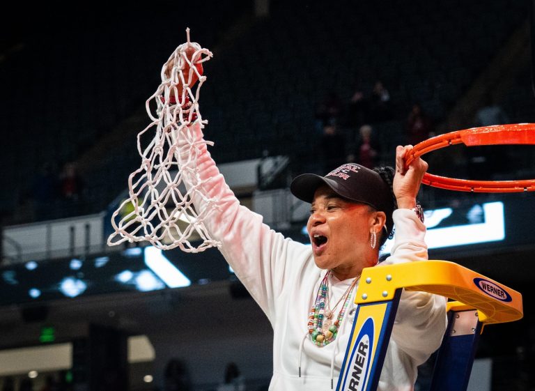 South Carolina Gamecocks head coach Dawn Staley cuts down the net as the Gamecocks celebrate their NCAA Regional Final game win over Duke