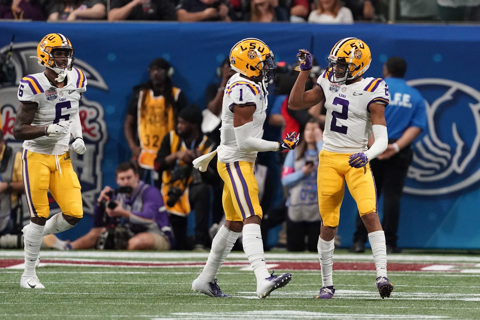 LSU Tigers wide receiver Justin Jefferson (2) celebrates with wide receiver Ja'Marr Chase (1) and wide receiver Terrace Marshall Jr. (6) after catching a pass for a touchdown against the Oklahoma Sooners during the first quarter of the 2019 Peach Bowl college football playoff semifinal game.