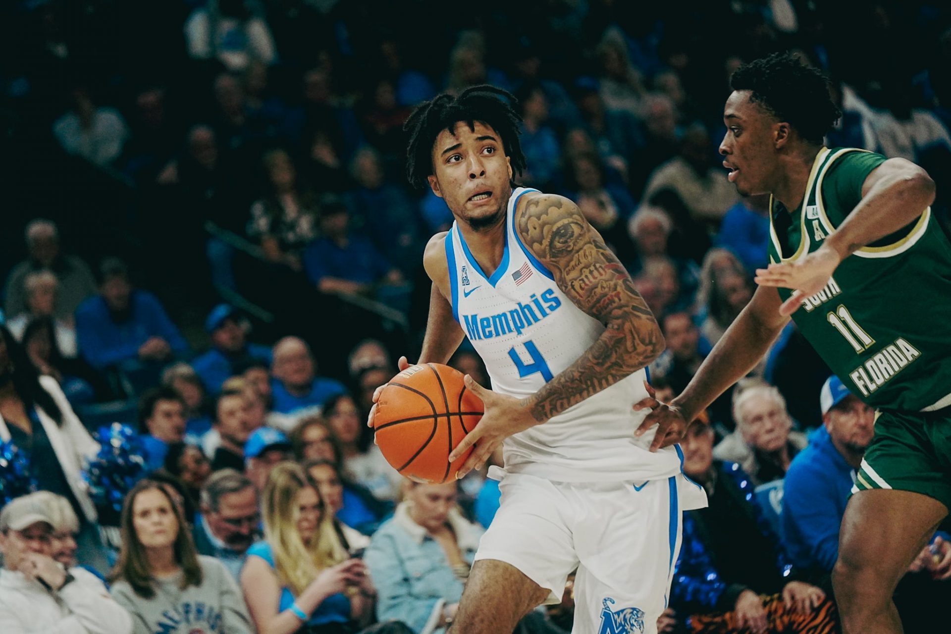 Memphis Tigers’ PJ Haggerty (4) looks to make a move against South Florida’s CJ Brown (11) during a game on Friday, March 7, 2025 at the FedEx Forum in Memphis, Tenn.