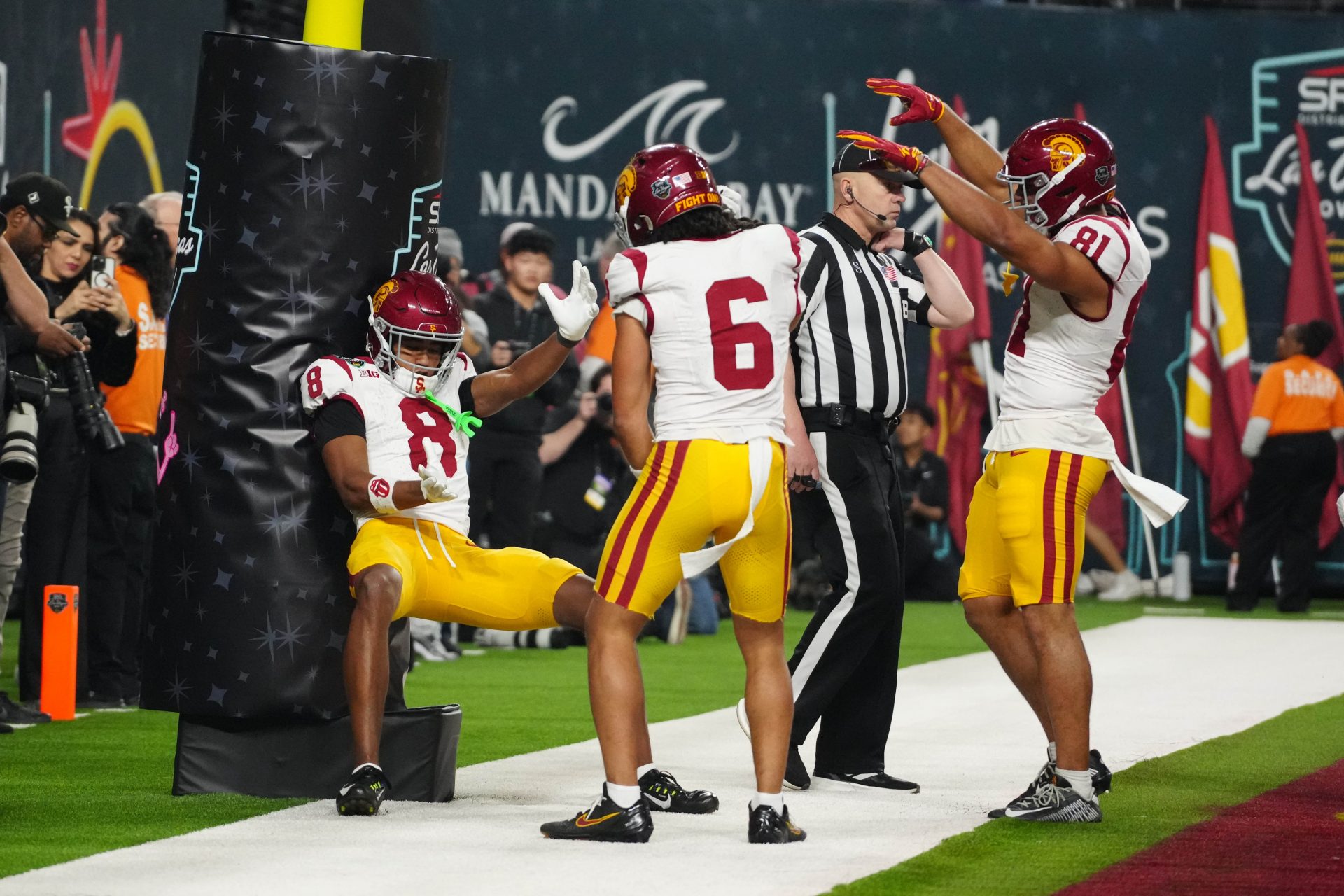 Southern California Trojans wide receiver Ja'Kobi Lane (8) celebrates with wide receiver Makai Lemon (6) and wide receiver Kyle Ford (81) after scoring on a 15-yard touchdown run against the Texas A&M Aggies in the fourth quarter at Allegiant Stadium.