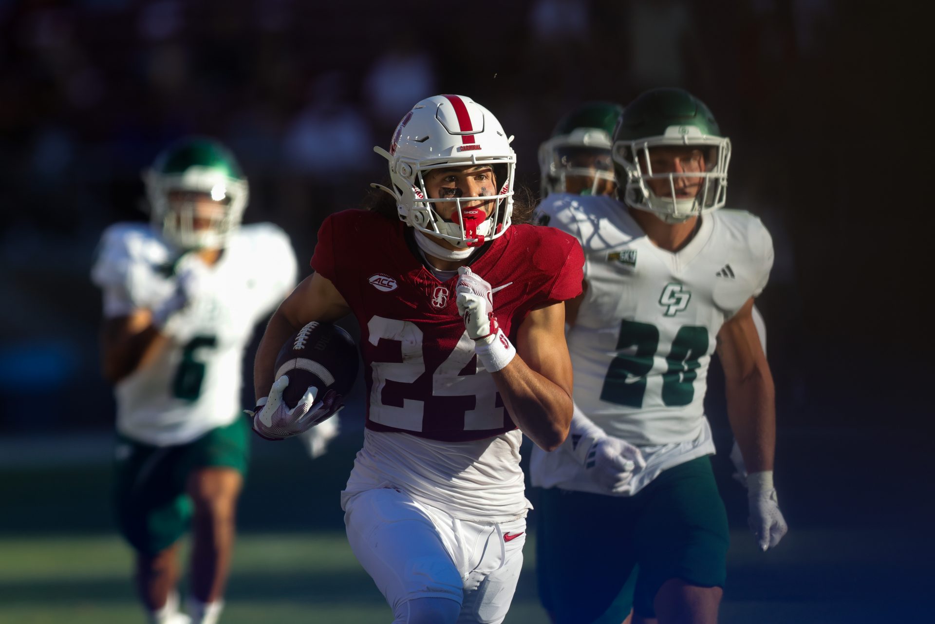 Stanford Cardinal wide receiver Tiger Bachmeier (24) returns a punt for a touchdown against the Cal Poly Mustangs during the second half at Stanford Stadium.