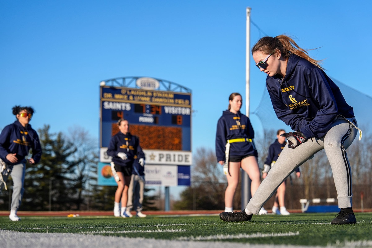 Alexa Brewster, of the Siena Heights women’s flag football team, warms up with her teammates before practice at O’Laughlin Stadium at Siena Heights University in Adrian on Tuesday, Feb. 25, 2025.