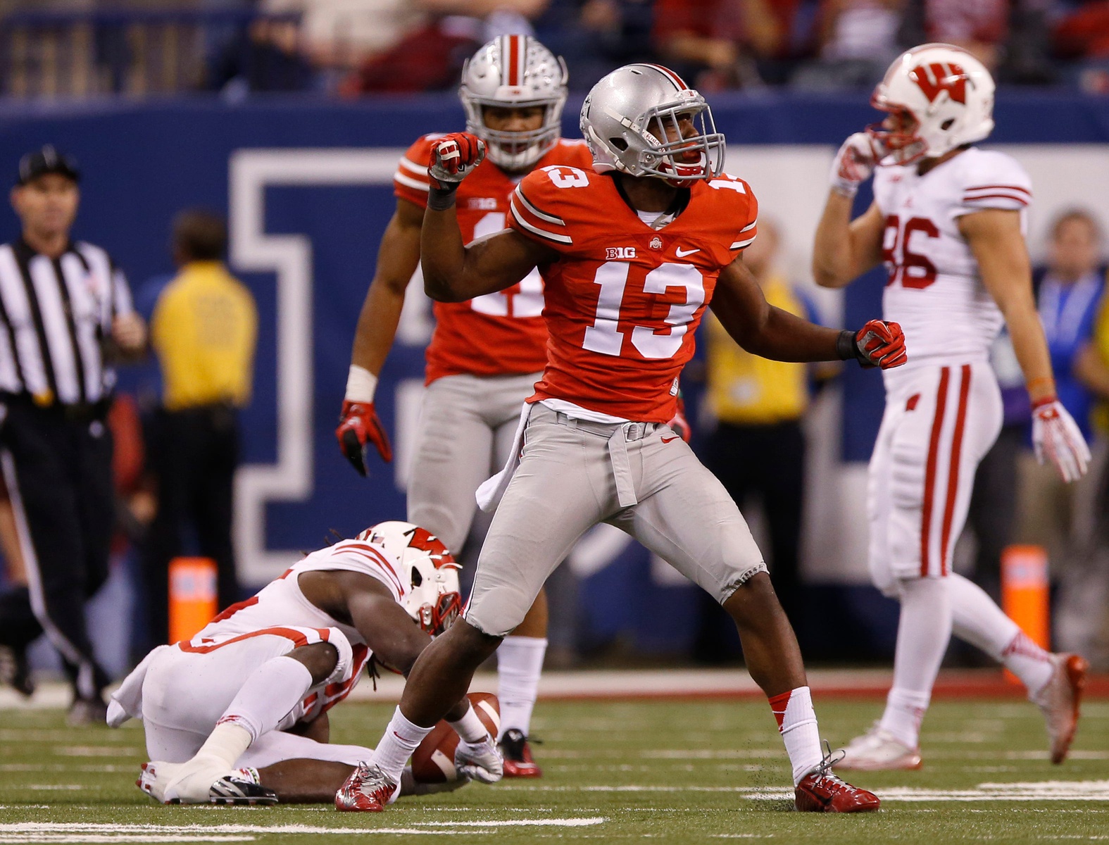 Ohio State Buckeyes cornerback Eli Apple (13) celebrates making a tackle on Wisconsin Badgers running back Melvin Gordon (25) during the third quarter of the Big Ten Championship game against the Wisconsin Badgers at Lucas Oil Stadium in Indianapolis on Dec. 6, 2014. (Adam Cairns / The Columbus Dispatch)