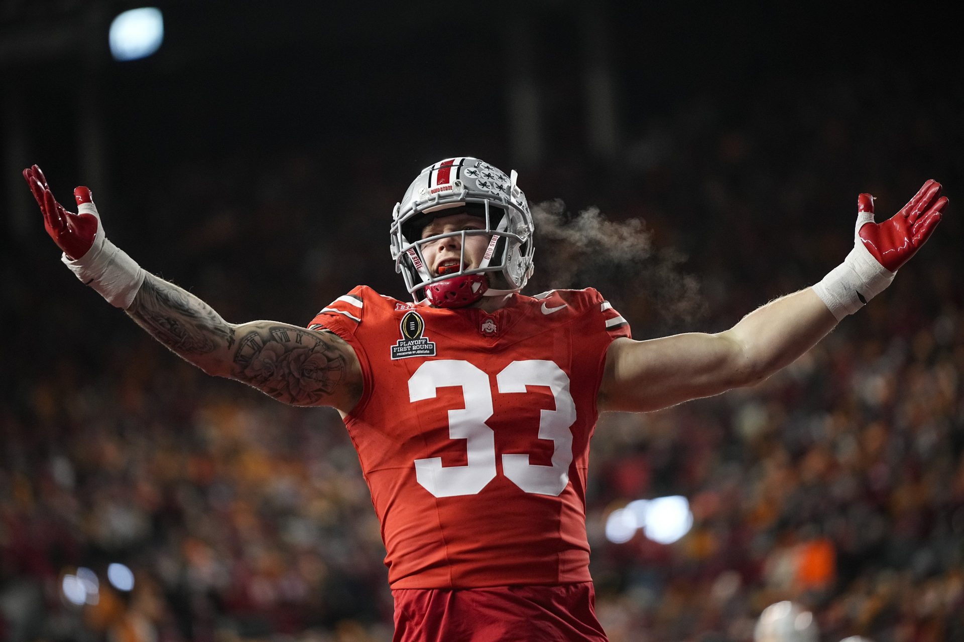 Ohio State Buckeyes defensive end Jack Sawyer (33) celebrates a sack of Tennessee Volunteers quarterback Nico Iamaleava (8) during the first half of the College Football Playoff first round game at Ohio Stadium in Columbus on Dec. 21, 2024.