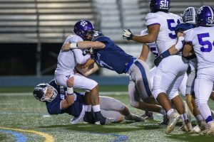 Cherry Hill West's Jordon DeJesus Gonzalez is sacked by Middletown South's Colin Gallagher and Luke Wafle during the first half of the Cherry Hill West vs. Middletown South NJSIAA Central Group 4 playoff football game at Middletown High School South in Middletown, NJ Friday, October 28, 2022.Mid03