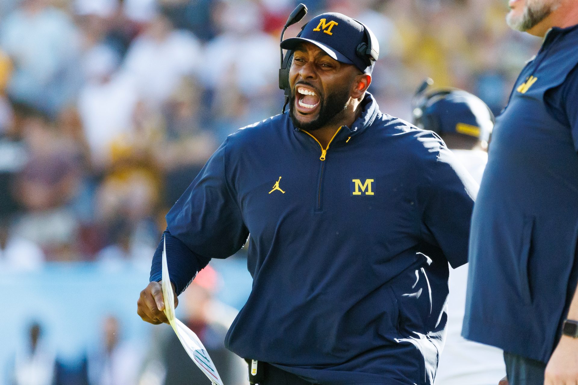 Michigan Wolverines head coach Sherrone Moore screams from the sideline against the Alabama Crimson Tide during the second half at Raymond James Stadium.