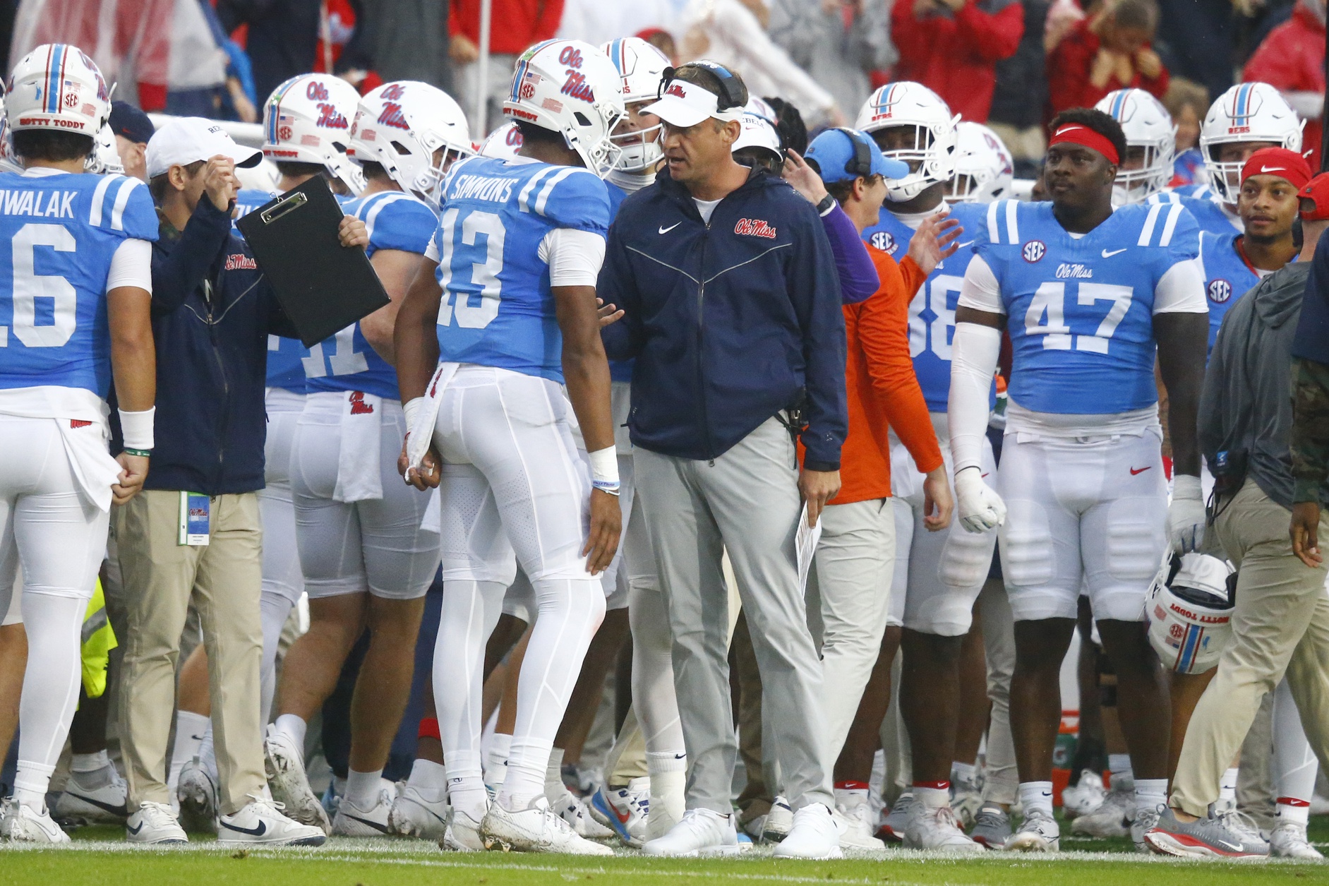 Mississippi Rebels head coach Lane Kiffin talks with quarterback Austin Simmons (13) after a touchdown during the first half against the Georgia Bulldogs at Vaught-Hemingway Stadium.