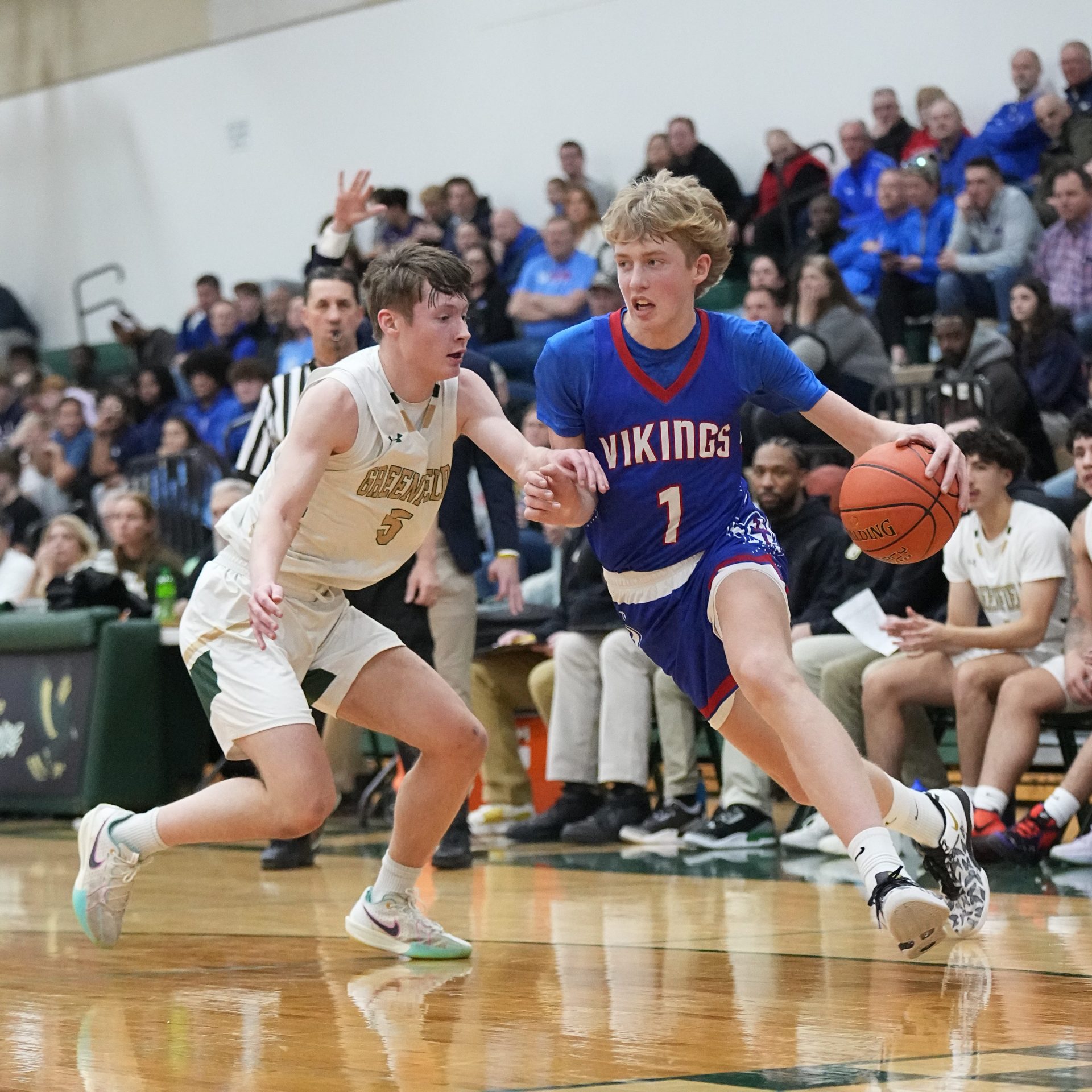 Wisconsin Lutheran's Kager Knueppel (1) breaks past Greenfield's Mason Stieber-Pinter (5) during the game at Greenfield, Wednesday, February 26, 2025. Wisconsin Lutheran won the game, 93-59.
